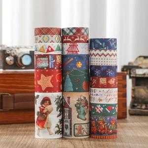 Macro shot of vintage Christmas washi tape set with reindeer and snowflake patterns