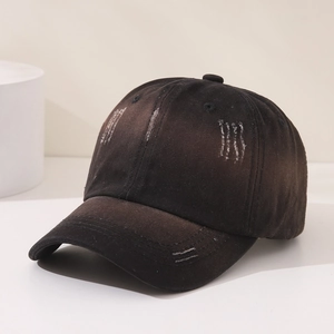 Detail of distressed cotton baseball cap with vintage worn holes and 6-panel structure