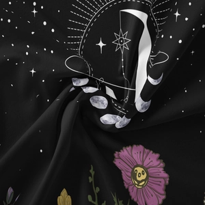 Close-up of soft polyester moon phase tapestry fabric with floral and celestial patterns