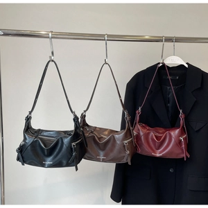 Detailed view of large leather tote bags in black, coffee, and wine red colors