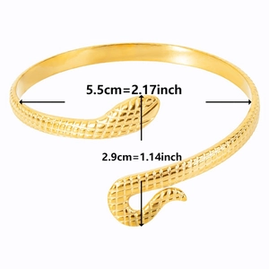 Detail view of a gold snake cuff bracelet showing scale texture and 5.5cm inner diameter