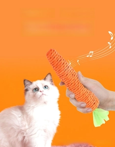 Ragdoll cat playing with a woven carrot toy featuring a bell for interactive play