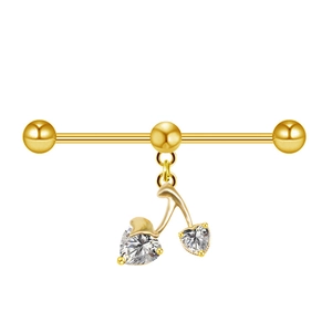 Detailed close-up of golden industrial barbell with cherry heart cubic zirconia pendant