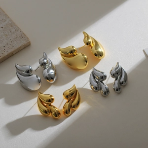 Polished 18K gold and silver double teardrop brass earrings in abstract geometric style