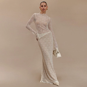 Detail of sheer beige lace long sleeve top and matching skirt set on a model