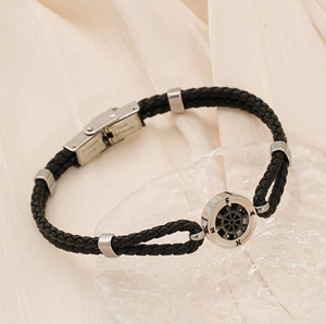 Detail of nautical braided leather bracelet with customizable stainless steel compass clasp