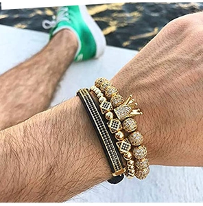 Detailed view of luxury men's crown and bead bracelet set worn on wrist in natural light