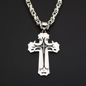 Macro shot of silver stainless steel double-layered cross pendant with black oil finish