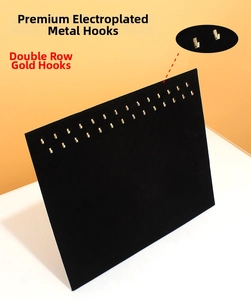 Close-up of black velvet jewelry board with 20 double-row golden metal hooks for necklaces