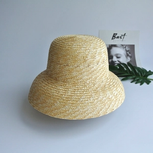 French vintage straw cloche sun hat in beige with fine weave on a minimalist background