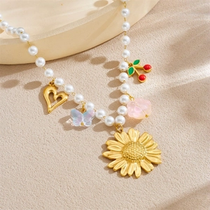 Gold-plated pearl necklace with sunflower, cherry, heart and butterfly charms