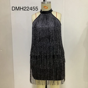 Close-up of black fringe halter party dress featuring sparkling glitter and layered tassels