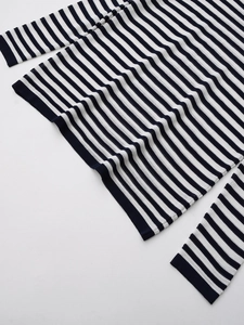 Close-up of high-quality black and white striped knit texture on a casual long sleeve top