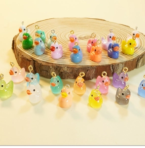 Macro shot of colorful resin duck charms with metal eyelet screws for DIY jewelry making