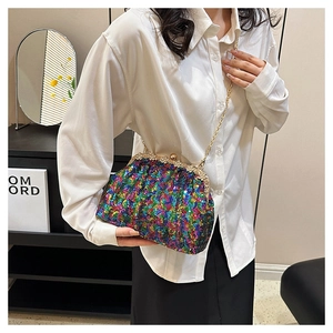 Close-up of colorful iridescent sequins on a shell-shaped evening bag with a gold chain