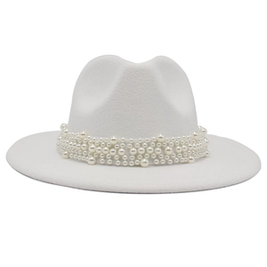 Detail of white fedora hat featuring elegant multi-row pearl embellishment and wool felt