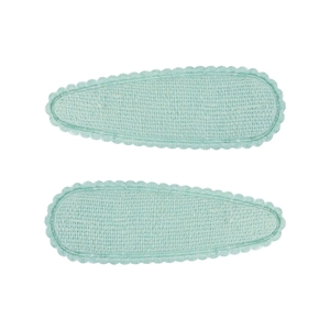 Détail de barrettes à cheveux en tissu vert menthe avec bords festonnés pour petites filles