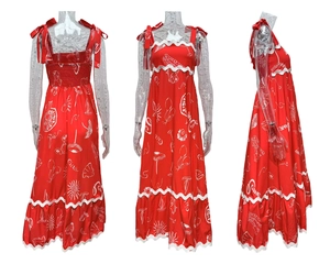 Detail of red floral maxi dress with shoulder bows and white wavy trim accents