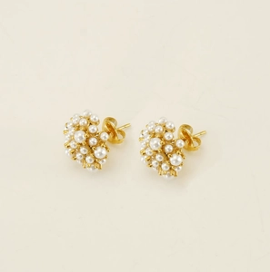 Macro detail of gold-plated cluster pearl stud earrings with secure butterfly backs