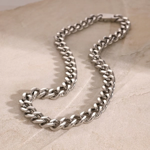 Detailed close-up of a high-polish silver Cuban link necklace with a square buckle clasp