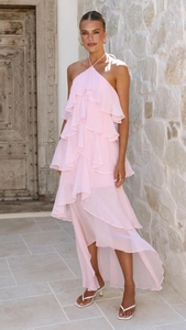 Detail of pink tiered ruffle halter dress with flowing chiffon texture in outdoor setting