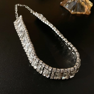Macro detail of luxury silver choker with rows of sparkling rectangular and round rhinestones