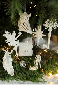 Detail of white glitter hollow Christmas ornaments hanging on a festive tree branch