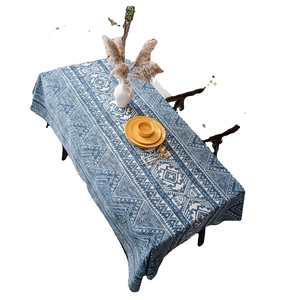 Blue linen tablecloth with white geometric patterns, elegant table setting on white