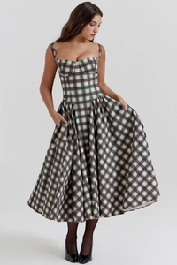 Detail view of red and green plaid midi dress with adjustable spaghetti straps and waist