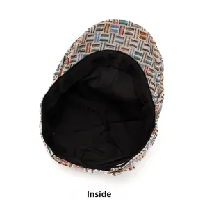 Close-up of the vintage jacquard newsboy cap showing black inner lining and buckle