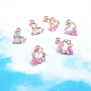 Detail of pink heart and star barbells with rose gold finish and zircon inlays