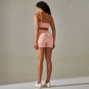 Detail view of seamless high-waist peach yoga set showing back cutout and lift effect