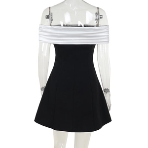 Rear view of contrast black and white off-shoulder mini dress on display mannequin