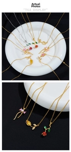 Detailed macro view of golden rose and tulip pendants with colorful enamel inlay charms
