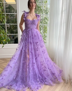Macro detail of lavender tulle gown showing 3D butterfly appliques and sweetheart neckline