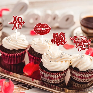 Close-up of glittery red Valentine's Day cupcake toppers with XOXO and Kiss Me designs