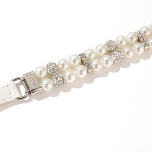 Detailed macro view of double-layer pearl pet collar with crystal balls and silver buckle