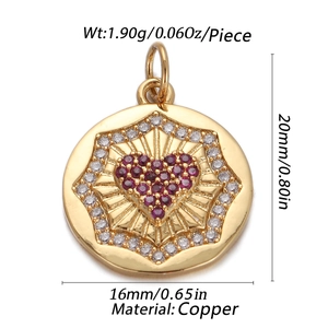 Detail view of round gold pendant with red heart and star engraving, 16mm x 20mm copper piece