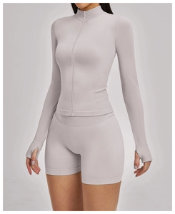 Detail of slim fit yoga jacket with thumbholes and high waist sports shorts in mauve