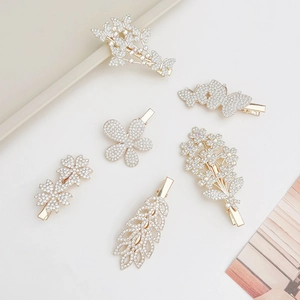 Set of six gold floral hair clips with crystals including butterfly and leaf shapes