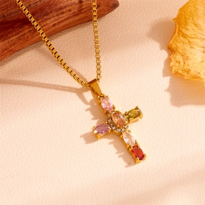 Macro view of golden cross pendant featuring six colorful gemstones with zircon halo detail