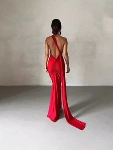 Elegant red one-shoulder evening dress featuring an open back and a long flowing train