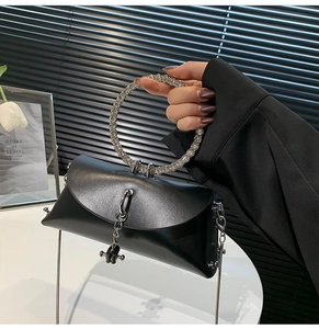 Elegant black PU leather handbag featuring a sparkling rhinestone ring handle and metal chain