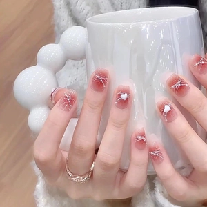 Short square press-on nails with red blush gradient, pearl accents and 3D heart charms