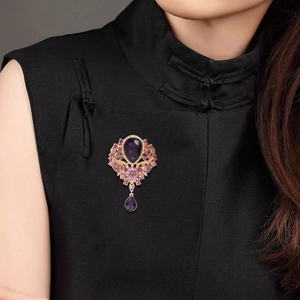 Vintage crystal pendant brooch with purple gems on elegant black dress collar