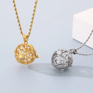 Detail of hollow sphere scent diffuser pendants in gold and silver twist chains