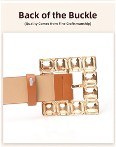 Macro view of gold square buckle back with clear gemstones and brown leather belt