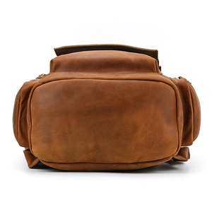 Detailed bottom view of large brown crazy horse leather travel backpack showing stitching
