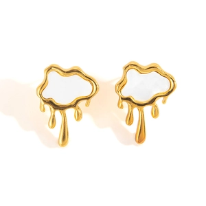 Detailed macro view of melting gold finish earrings with white irregular cloud inlay