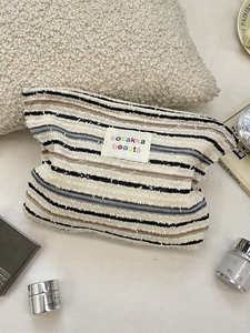 Striped knit makeup bag with colorful patterns and artistic label for daily cosmetics